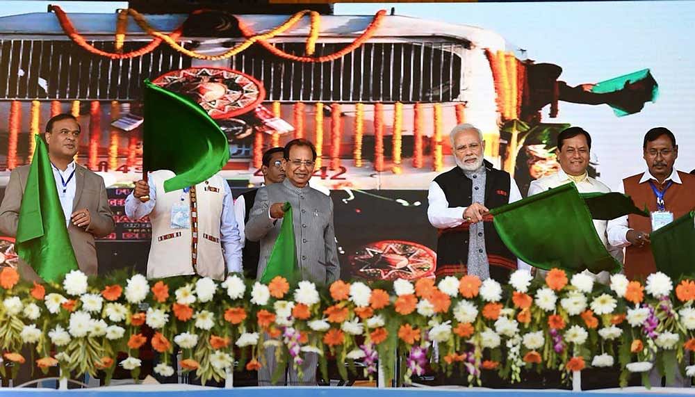 Prime Minister Narendra Modi flags off a passenger train after inaugurating the Bogibeel Bridge, the longest rail-cum-road bridge on Brahmaputra river, in Dibrugarh. PTI Photo 