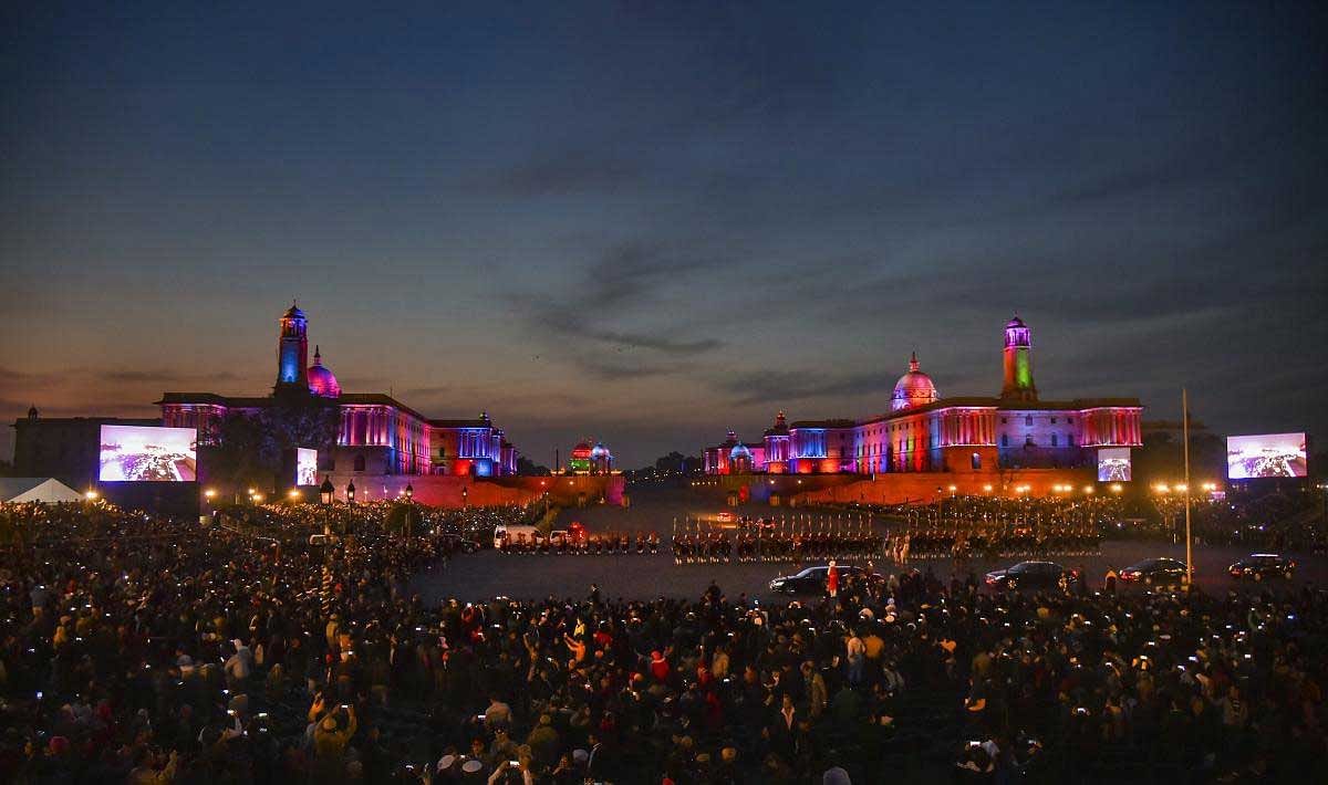 People click pictures of the illuminated Raisina Hills with their mobile phones, after the Beating Retreat ceremony at Vijay Chowk in New Delhi, Tuesday, Jan 29, 2019. (PTI Photo)
