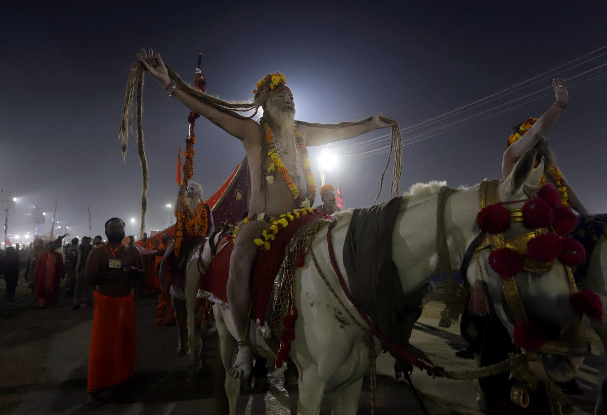 Naga Sadhus or Hindu holy men ride their horses as they arrive to take a holy dip in the waters of Sangam, the confluence of the Ganges, Yamuna and Saraswati rivers, during the second "Shahi Snan" (grand bath) at "Kumbh Mela" or the Pitcher Festival, in Prayagraj, previously known as Allahabad, India, February 4, 2019. REUTERS/Jitendra Prakash