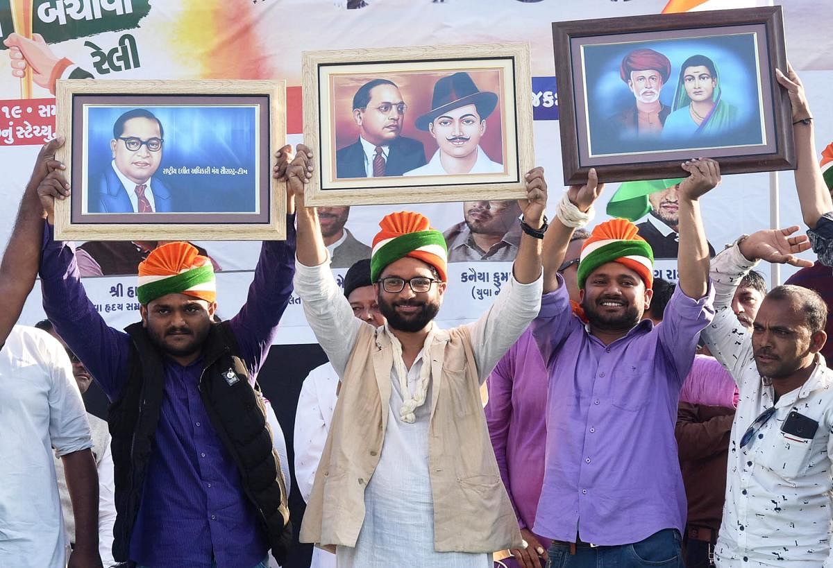Gujarat MLA Jignesh Mewani flanked by Patidar leader Hardik Patel and former JNU students Union president Kanhaiya Kumar (R) at a rally, in Rajkot, Wednesday, Feb 13, 2019. (PTI Photo) 