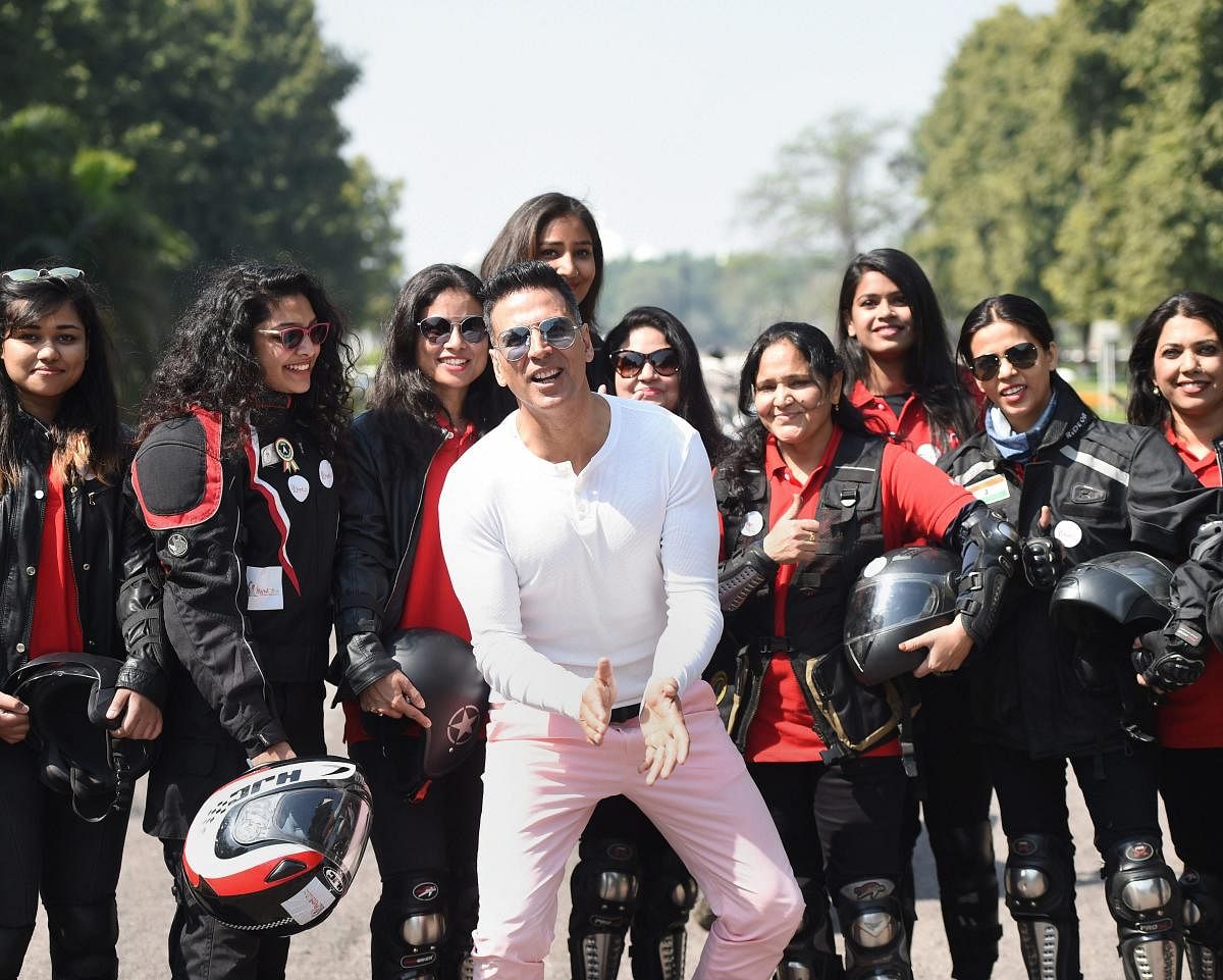 Lucknow: Bollywood actor Akshay Kumar poses with women bike riders during an event to mark International Women’s Day, in Lucknow, Friday, March 8, 2019. (PTI Photo/Nand Kumar) 