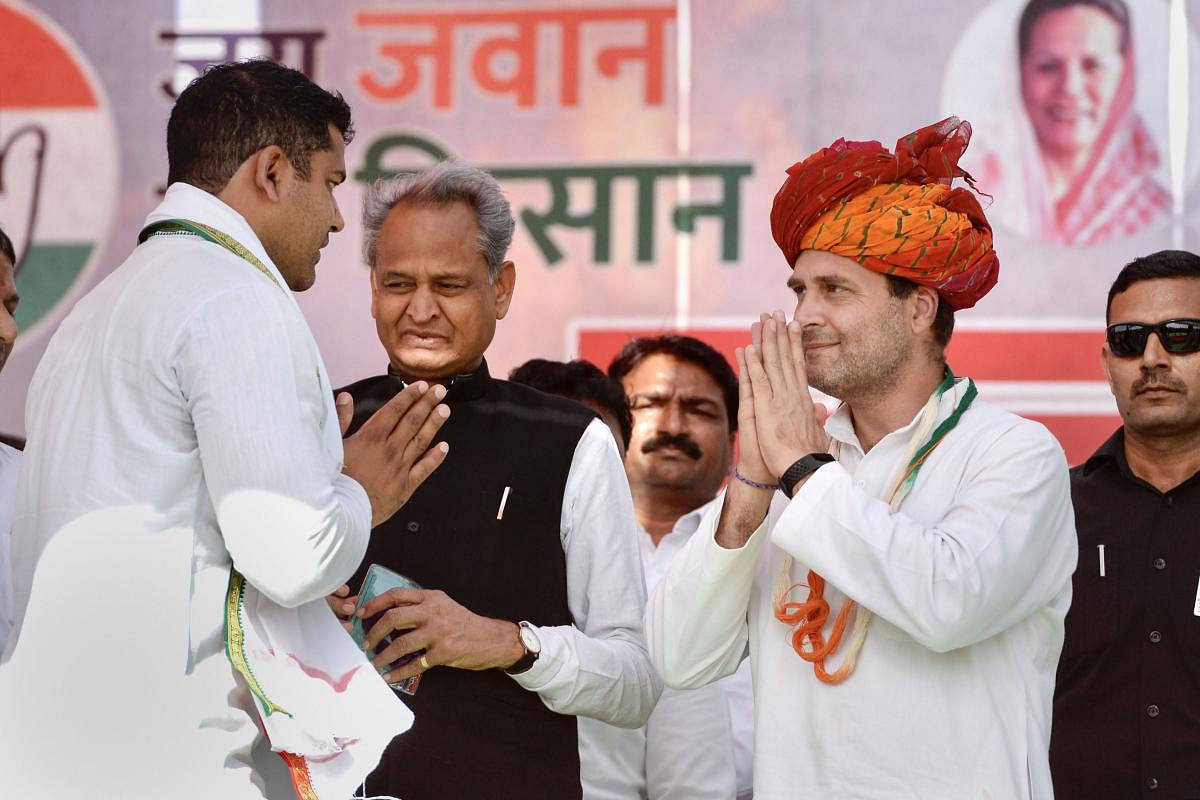 Congress President Rahul Gandhi is greeted by his party worker as Rajasthan Chief Minister Ashok Gehlot looks on during a public meeting, ahead of the Lok Sabha elections, in Bundi district, Tuesday, March 26, 2019. (PTI Photo)