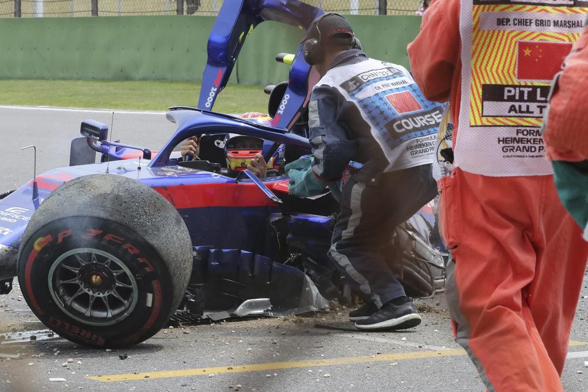 Shanghai : Toro Rosso driver Daniil Kvyat of Russia waits for help to get out of his crashed car during the third practice session for the Chinese Formula One Grand Prix at the Shanghai International Circuit in Shanghai on Saturday, April 13, 2019. AP/PTI