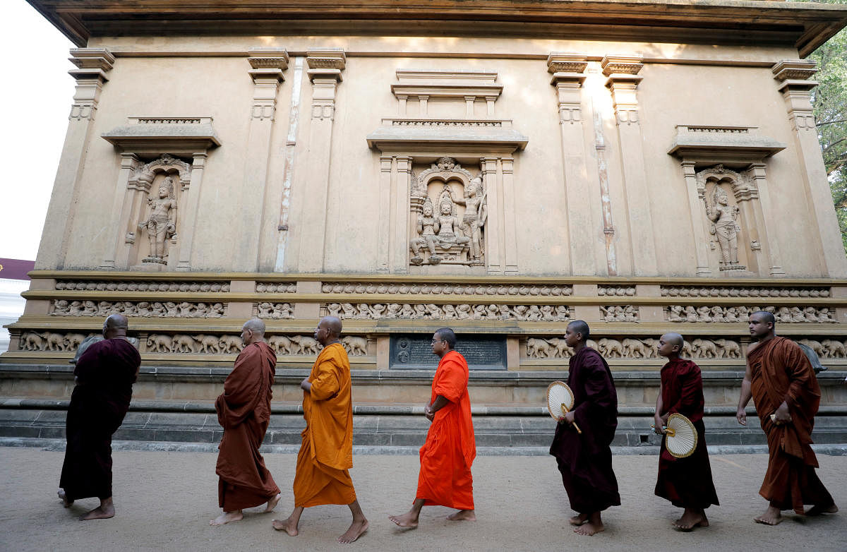 Buddhist monks take part in a prayer ceremony at a buddhist temple for the victims, three days after a string of suicide bomb attacks on churches and luxury hotels across the island on Easter Sunday, in Colombo, Sri Lanka April 24, 2019. REUTERS/Dinuka Liyanawatte