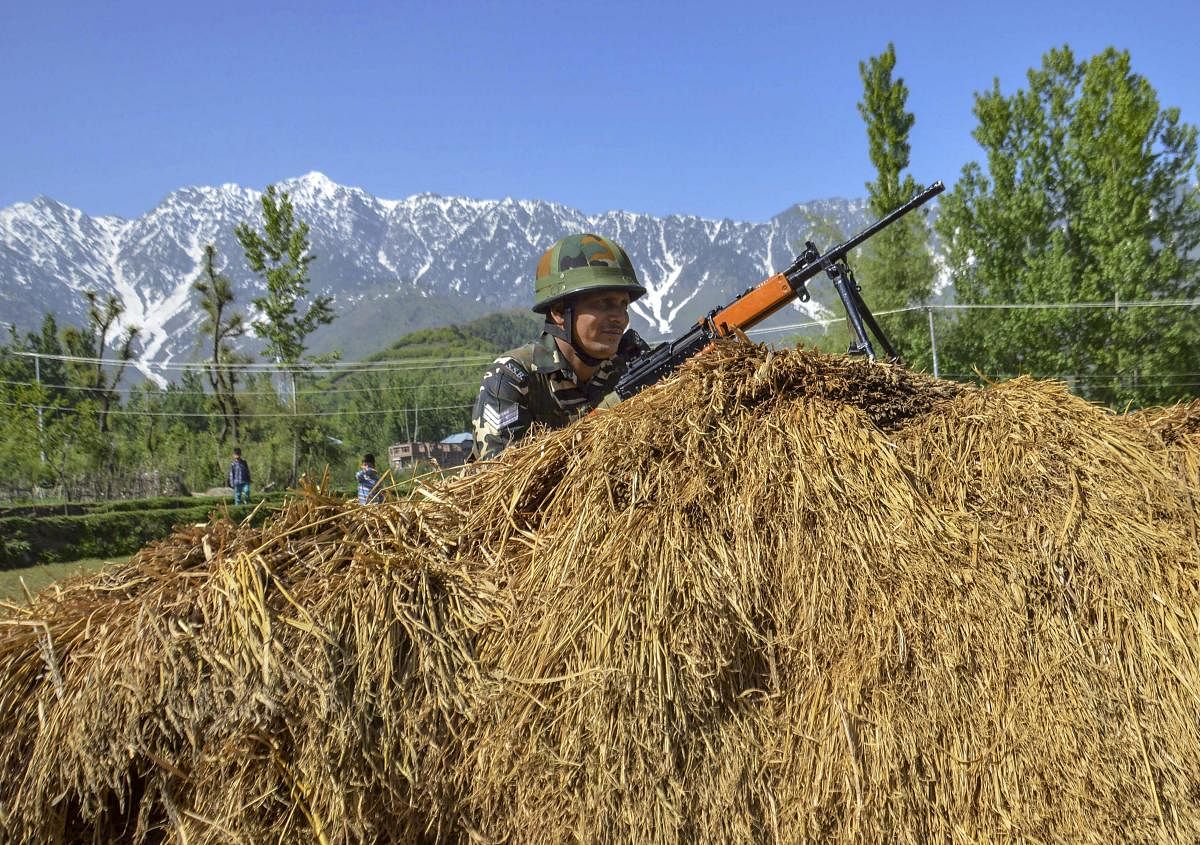 Security personnel guards a polling station during the fourth phase of Lok Sabha elections, in Kulgam. (PTI Photo) 