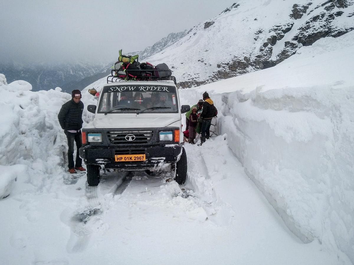 A tourist vehicle stuck on the Manali-Leh road following fresh snowfall, at Rohtang Pass in Himachal Pradesh. (PTI Photo)