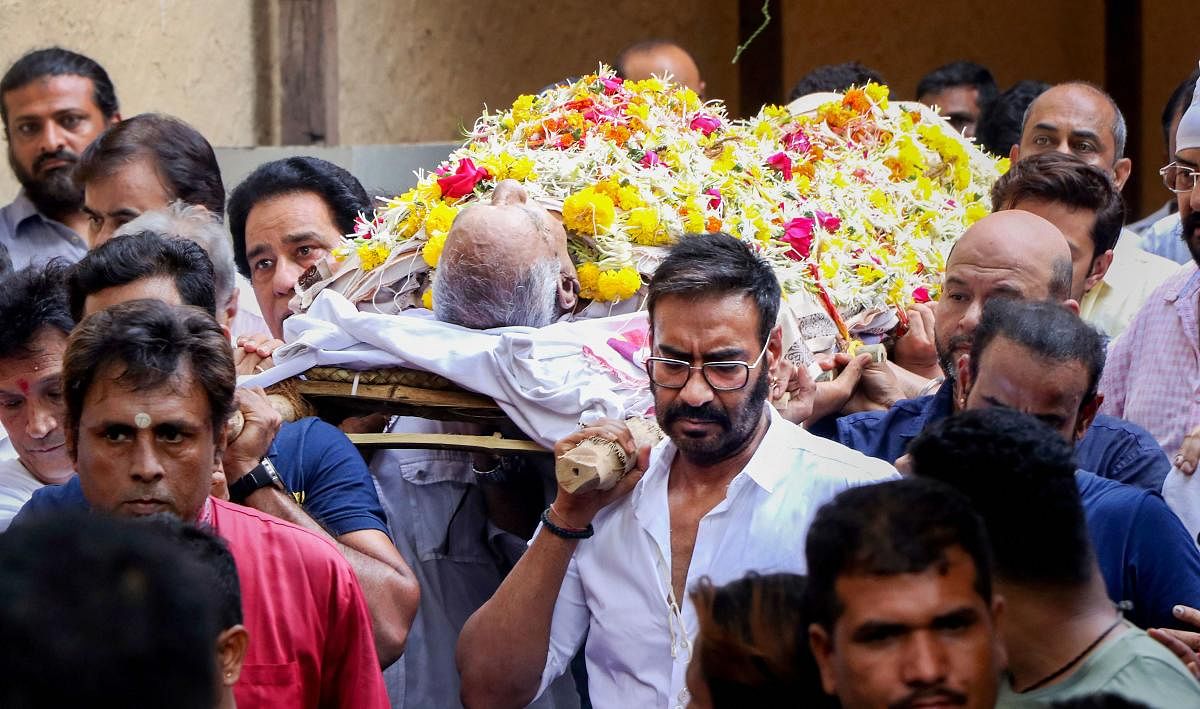 Bollywood actor Ajay Devgn carries the mortal remain of his father action director Veeru Devgan during his funeral in Mumbai. PTI Photo