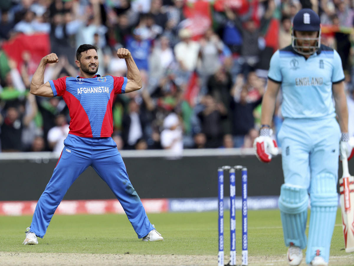 Afghanistan's captain Gulbadin Naib, left, celebrates the dismissal of England's Jonny Bairstow, right, during the Cricket World Cup match between England and Afghanistan at Old Trafford in Manchester, England, Tuesday, June 18, 2019. AP/PTI