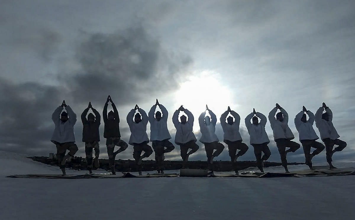 Indian Army personnel perform yoga to mark the 5th International Day of Yoga, in the icy ranges of the Himalayas, Friday, June 21, 2019. (PTI Photo) 