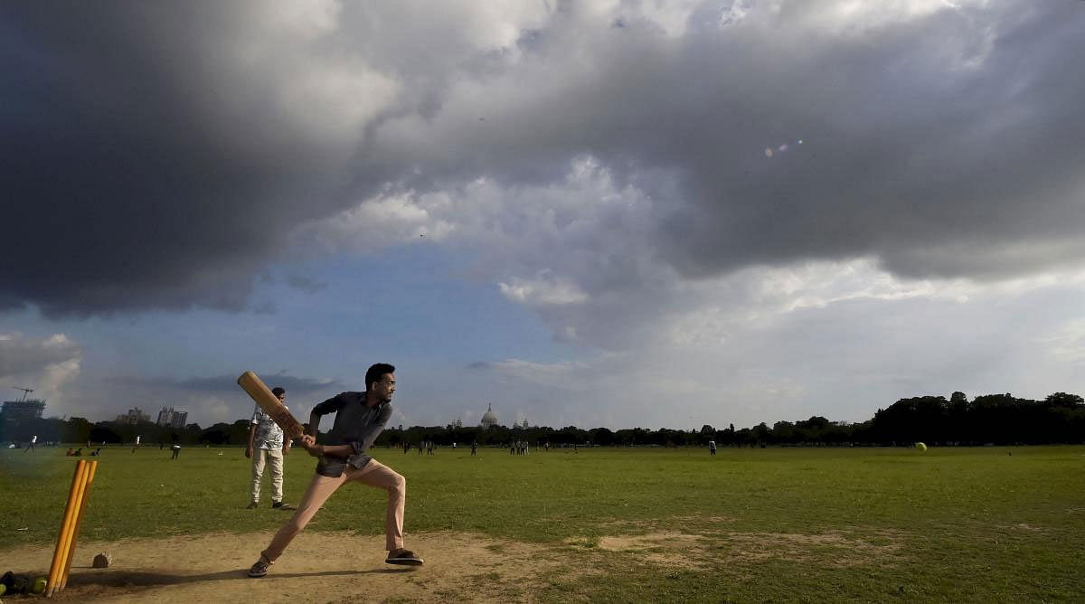 Boys play cricket during a cloudy weather at Kolkata Maidan in Kolkata, Sunday, June 23, 2019. (PTI Photo)