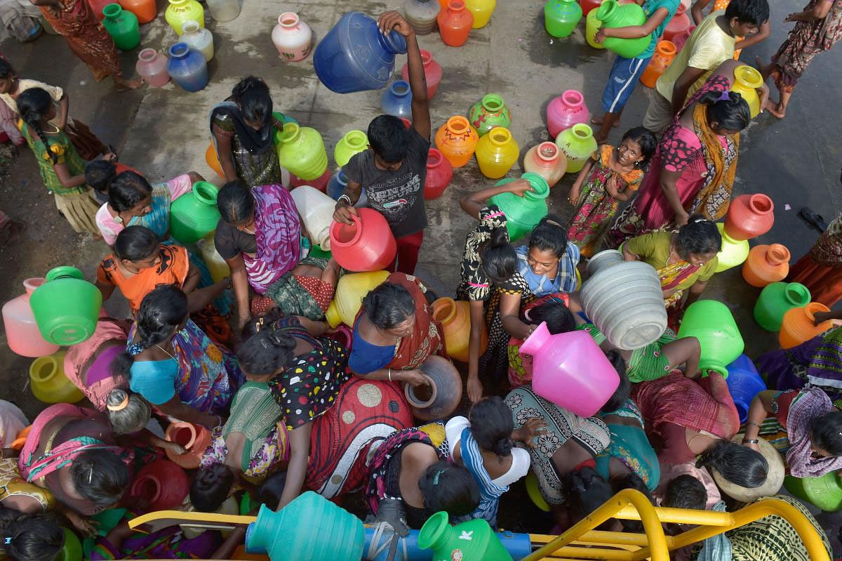 People rush to fill their vessels from a water tanker following acute water shortage, in Chennai, Wednesday, June 26, 2019. (PTI Photo)