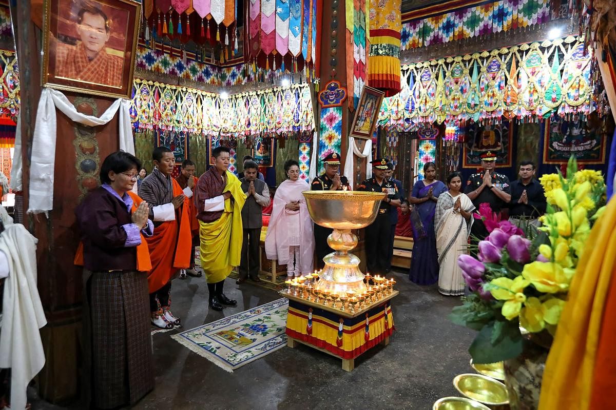 The portrait of former Indian foreign minister Sushma Swaraj is seen as Bhutan King Jigme Khesar Namgyel Wangchuck (unseen) offers prayers and butterlamps to her, at Simtokha Dzong in the Thimphu valley. AFP Photo