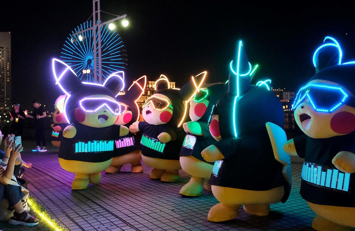 Performers dressed as Pikachu, the popular animation Pokemon series character, participate in a light performance during the Pikachu parade in Yokohama. (AFP Photo)