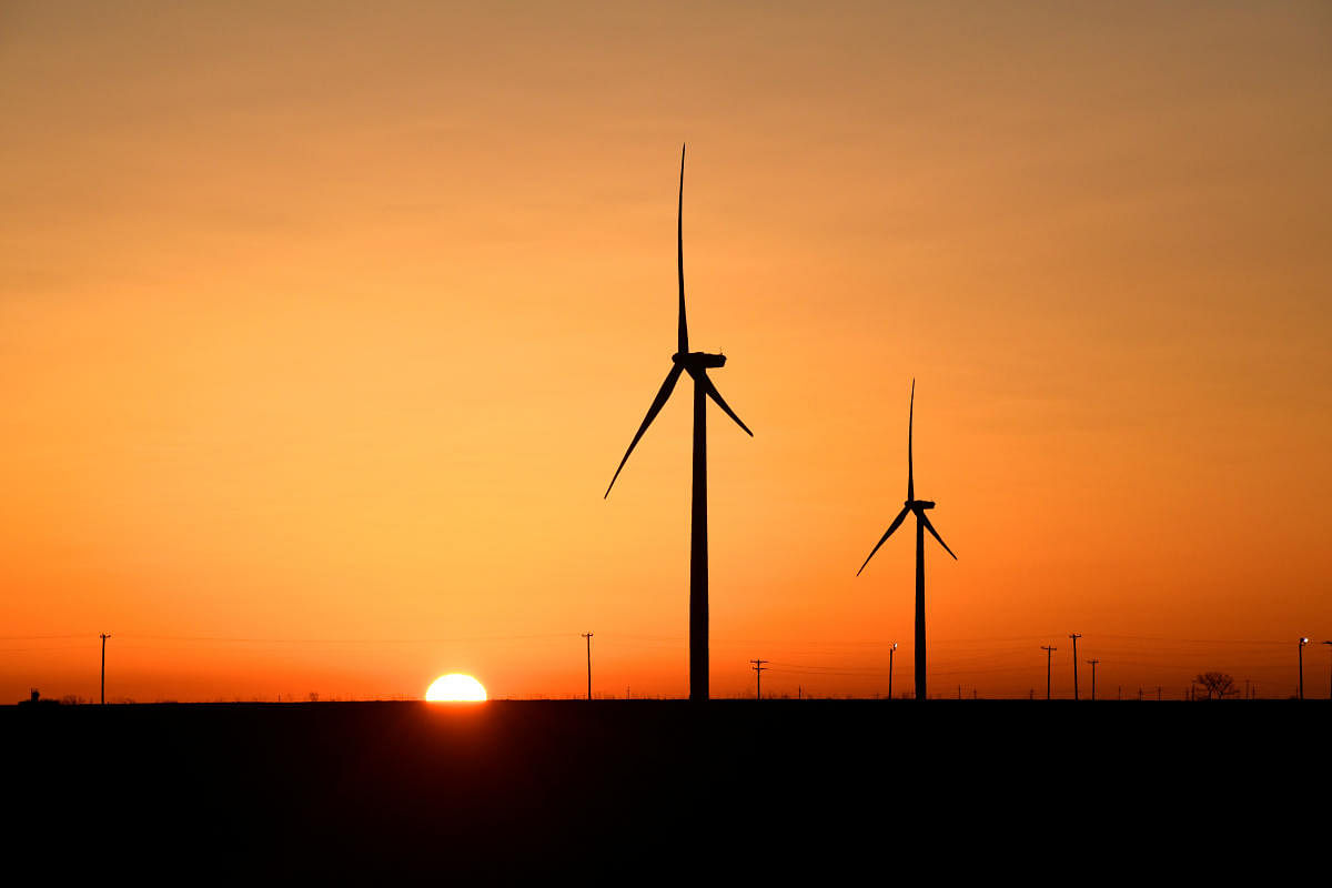 Wind turbines operate at sunrise in the Permian Basin oil and natural gas production area in Big Spring, Texas, U.S. (Reuters Photo)