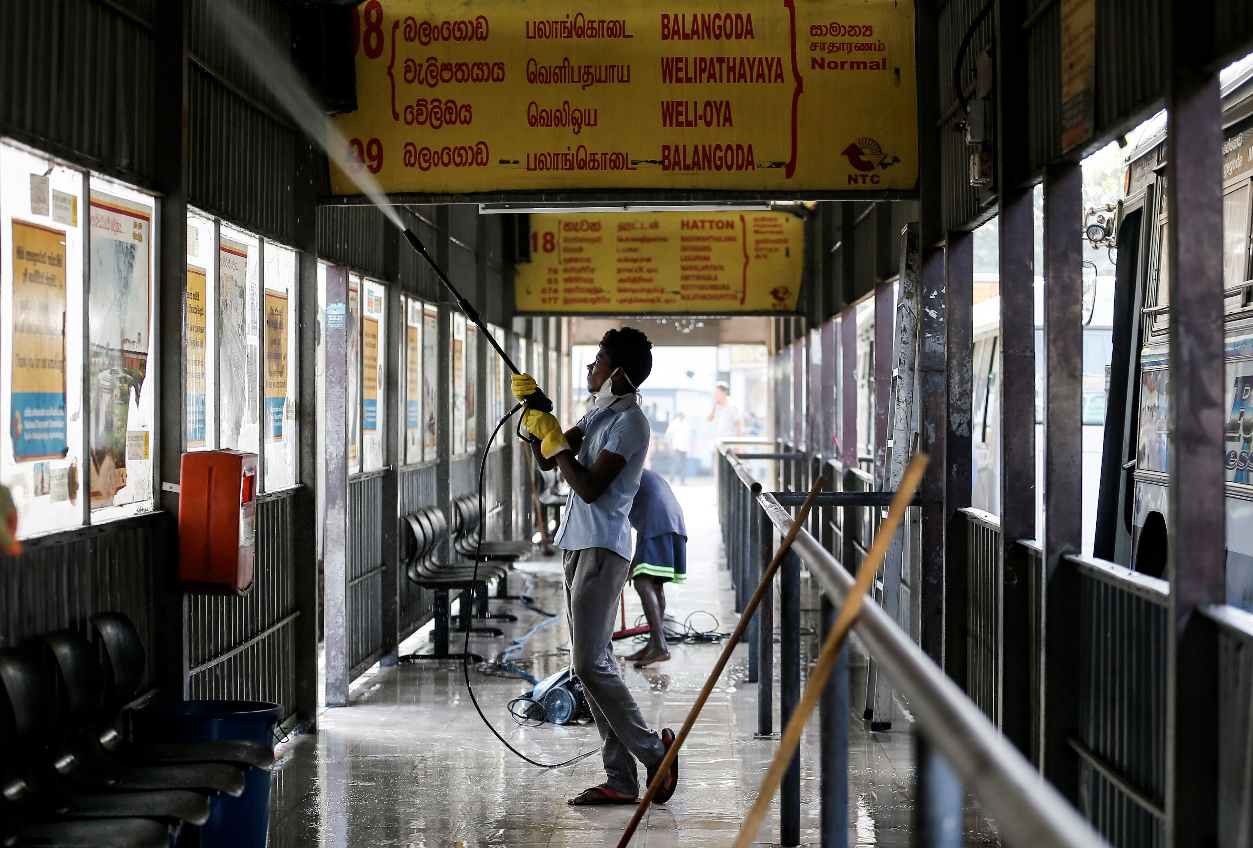 A worker cleans a private bus station, as the number of people tested positive for coronavirus (COVID-19) in the country increases to 18, in Colombo, Sri Lanka. (Reuters photo)