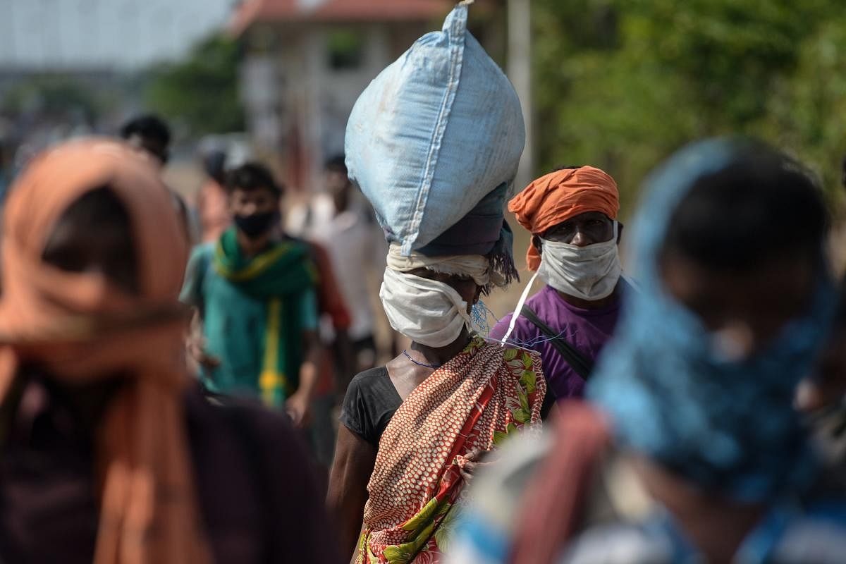 Migrant workers walk along a road as their return to their home towns in Jharkhand after the government eased a nationwide lockdown. (AFP Photo)