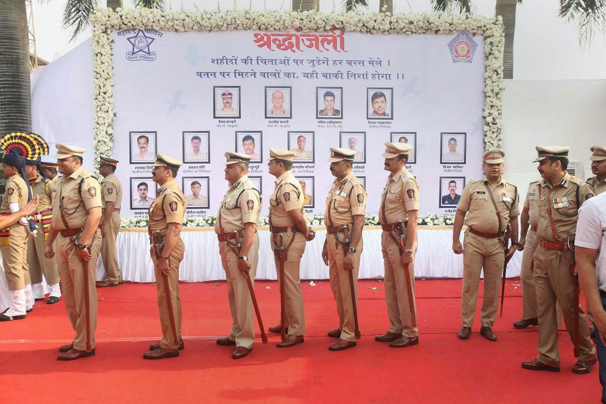 Mumbai Police personnel pay their tribute to martyrs of the 26/11 terror attacks on its tenth anniversary, at the Martyrs' Memorial, Police Gymkhana, in Mumbai, Monday, Nov. 26, 2018. On November 26, 2008, 10 Pakistani terrorists arrived by sea route and opened fire indiscriminately at people killing 166, including 18 security personnel, and injuring several others, besides damaging property worth crores. (PTI Photo)