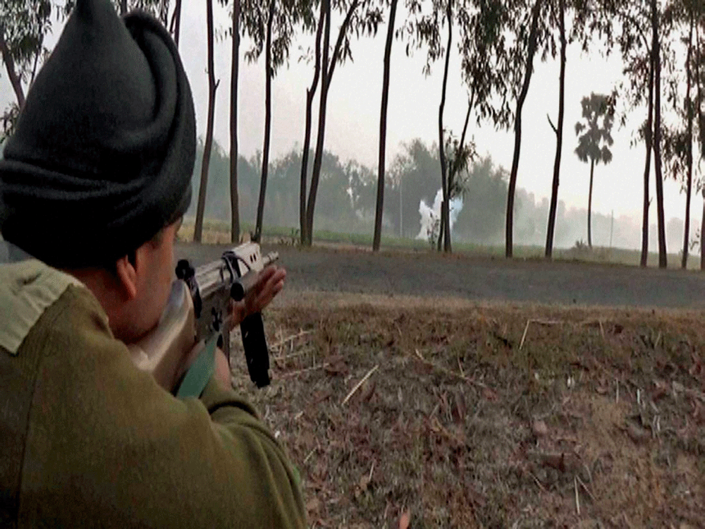 A Combat Force jawan takes position during a clash between TMC MLA Nanoor, Gadadhar Hazra Group & TMC leader Kajal Sk. group to capture Bahiri village at Bolpur in Birbhum district of West Bengal on Friday morning. PTI Photo.