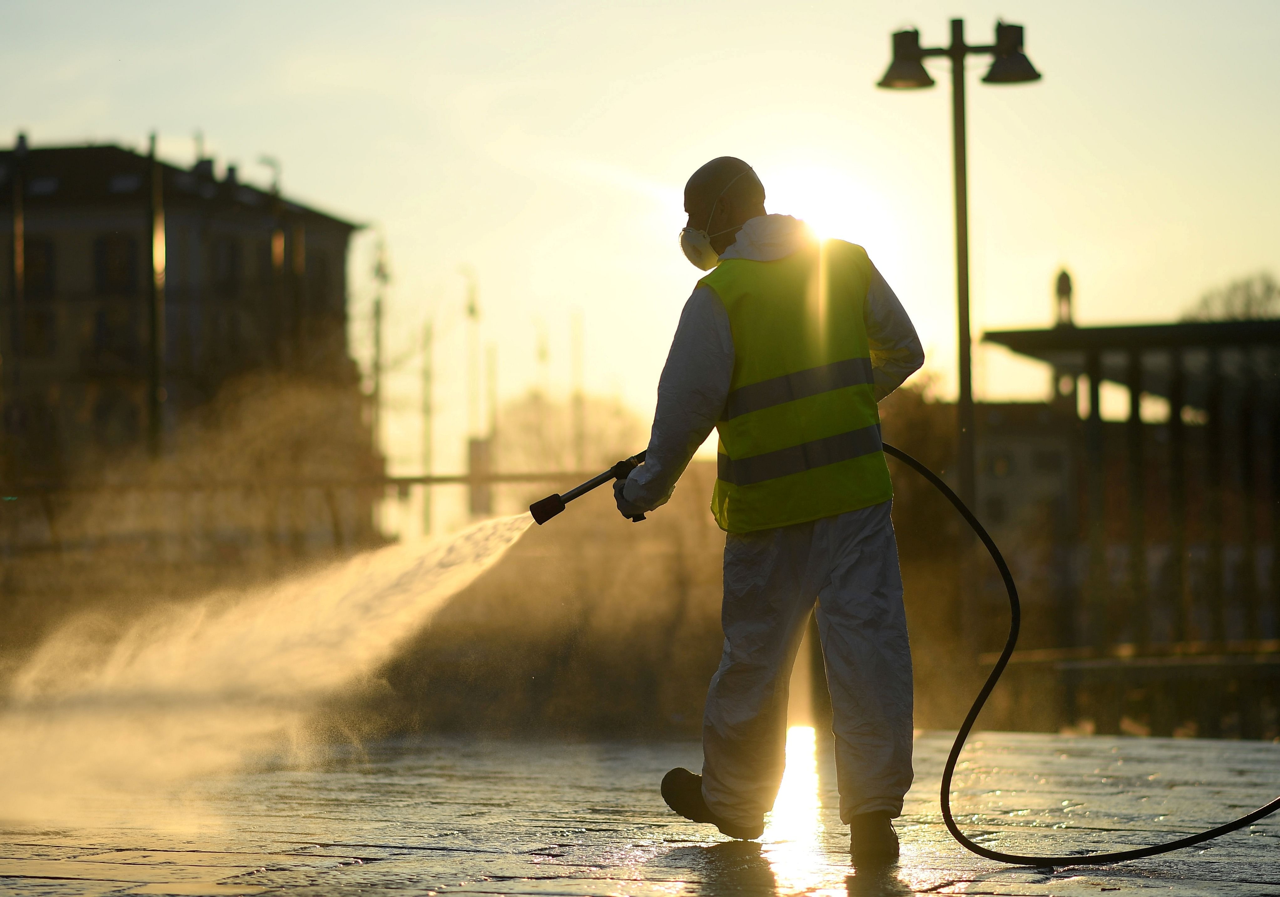 A worker sanitizes a street on the fourth day of an unprecedented lockdown across of all Italy. (Credit: Reuters)