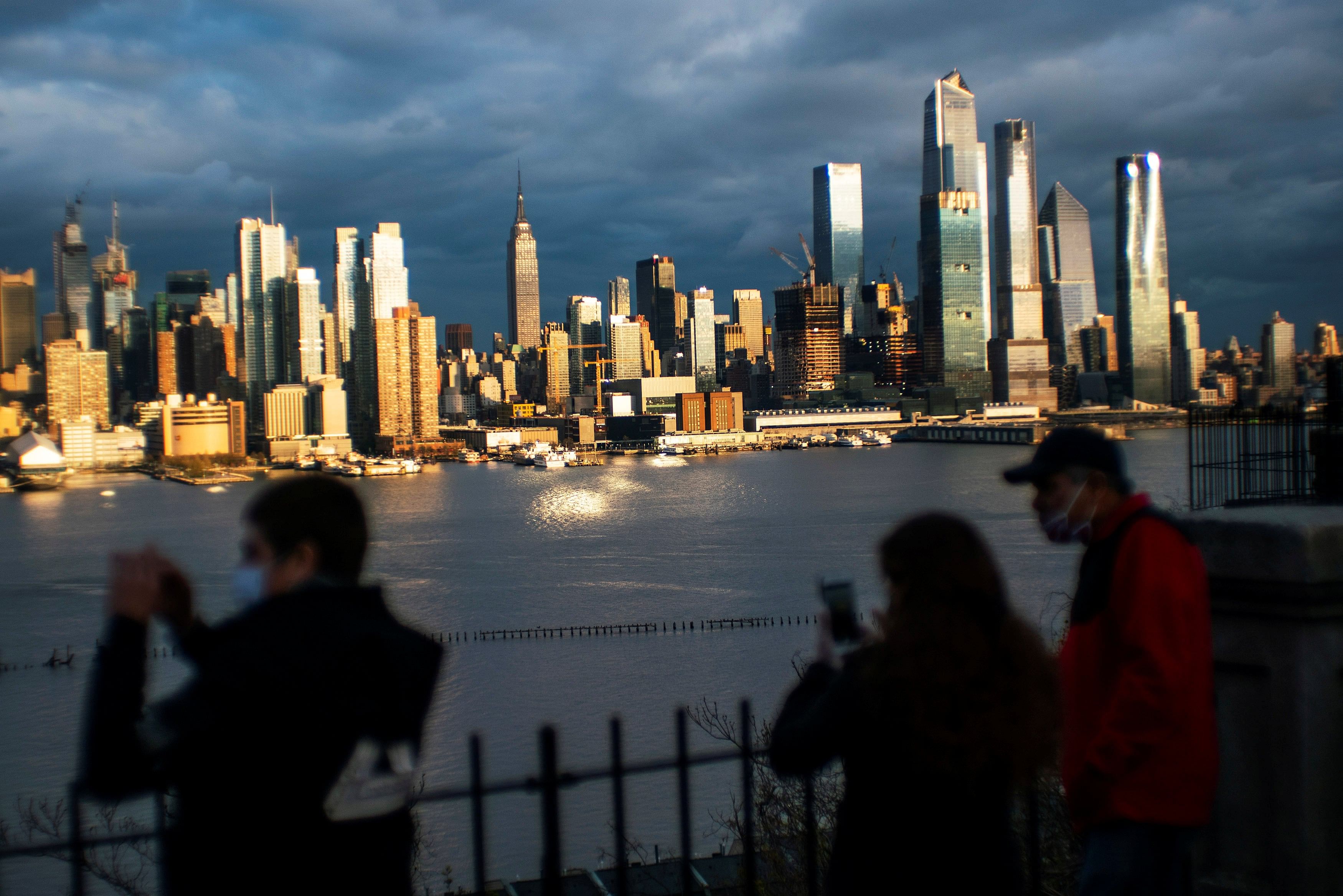 People take a look at the New York City skyline of Manhattan and the Hudson River during the outbreak of the coronavirus disease (COVID-19) in New York City, as seen from Weehawken, New Jersey. (Reuters Photo)