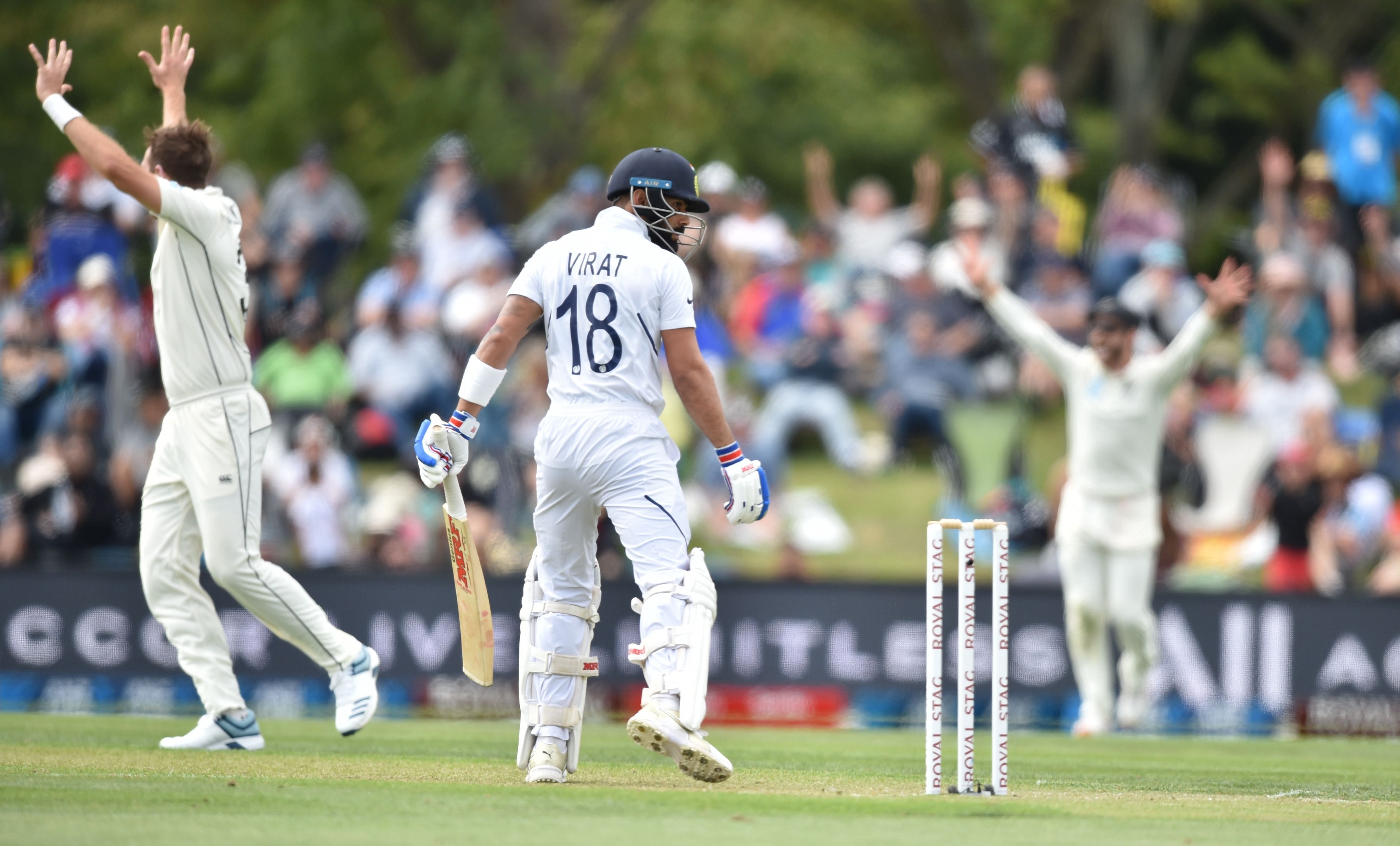 India's captain Virat Kohli (C) is bowled LBW by New Zealand's Tim Southee (L) on day one of the second Test cricket match between New Zealand and India at the Hagley Oval in Christchurch. (AFP Photo)