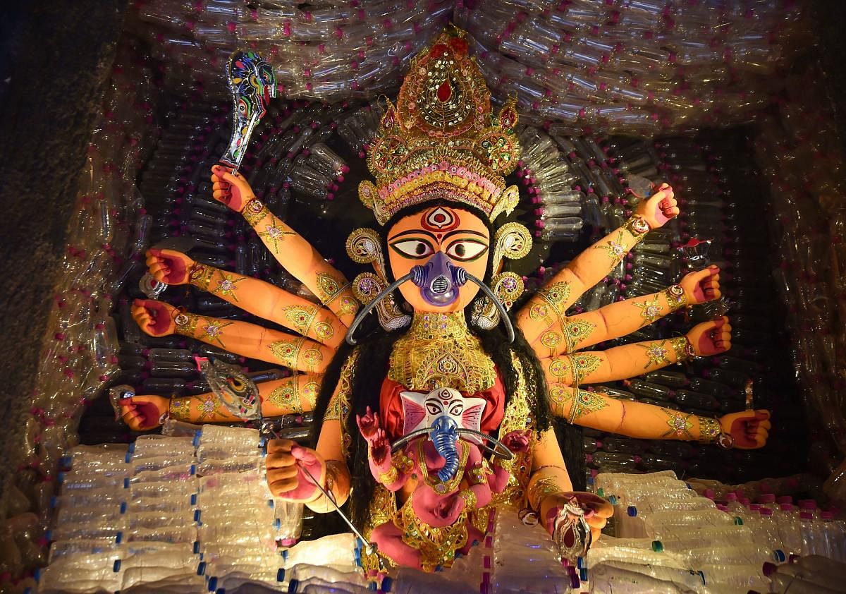  A clay idol of Goddess Durga, shown with a mask on to raise awareness against environment pollution and plastics, at a community puja pandal in Kolkata, Saturday, Oct. 5, 2019. (PTI Photo)