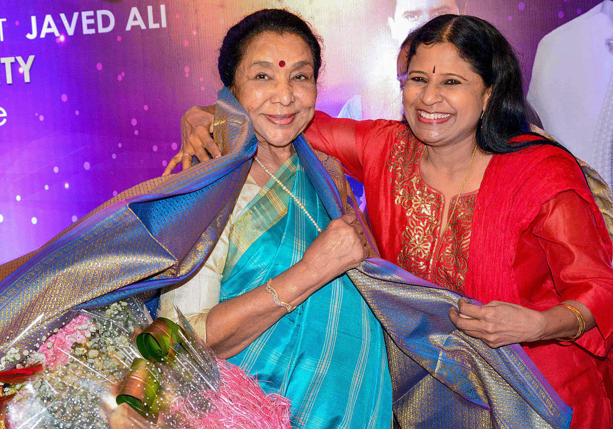  Indian playback singer Asha Bhosle being felicitated by Kannada singer B R Chaya in Bengaluru, on June, Friday. PTI Photo
