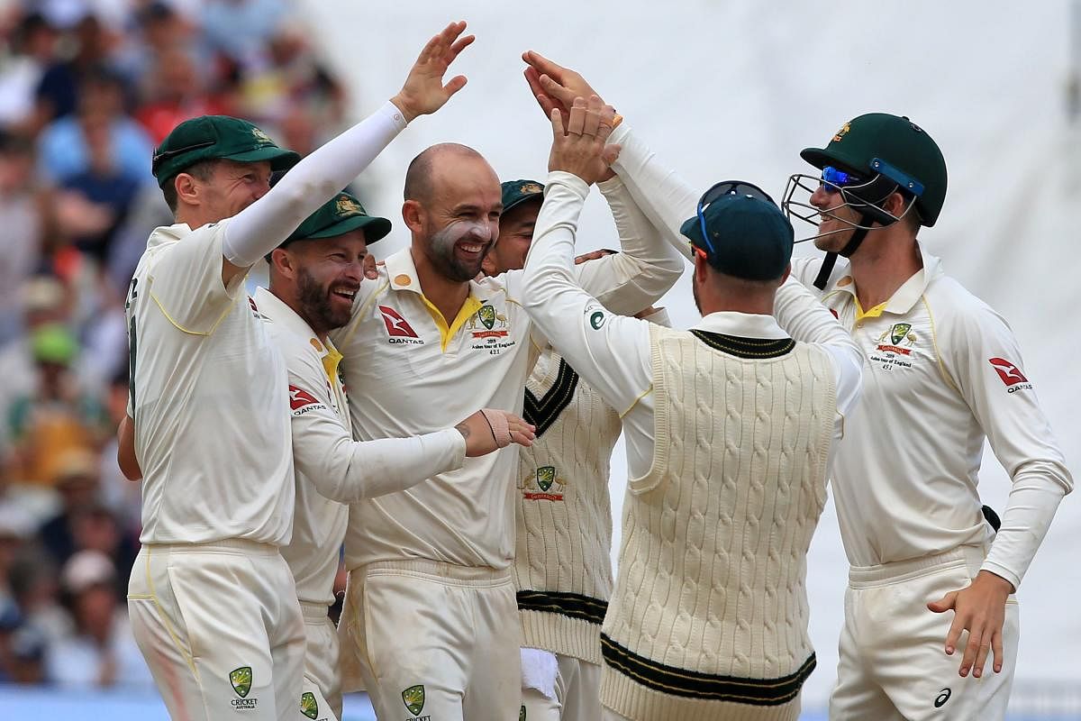 Australia's Nathan Lyon (C) celebrates after taking the wicket of England's Stuart Broad during play on the fifth day of the first Ashes cricket Test. (AFP Photo)
