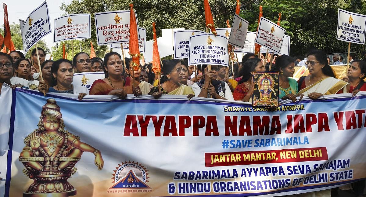   Lord Ayyappa devotees take part in the 'Ayyappa Namajapa Yatra' (chanting the name of Lord Ayyappa) in New Delhi on Sunday. (PTI Photo)