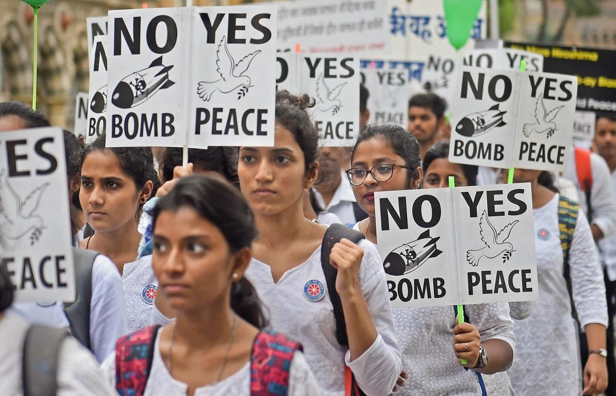 Students hold placards as they participate in a rally to commemorate Hiroshima Day, in Mumbai on Monday. PTI Photo