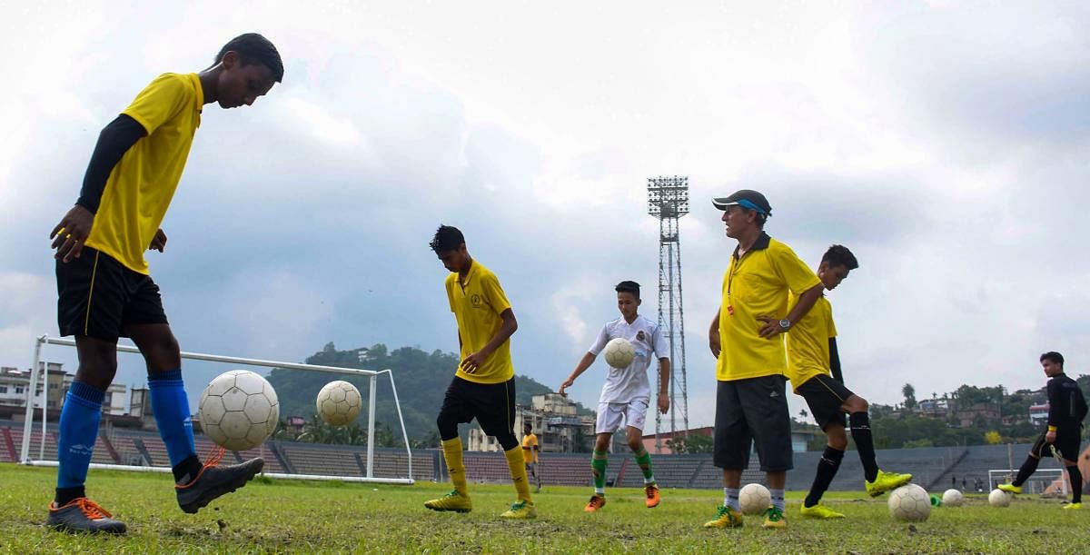 Young footballers practice the sport at a coaching centre as FIFA fever grips various parts of the country, in Guwahati on Thursday. PTI Photo