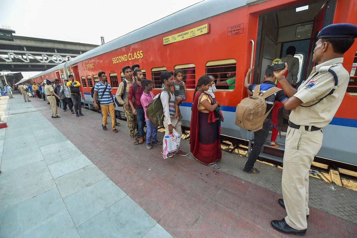   Migrant workers wait to board a train out of Gujarat in view of protests and violence breaking out over the alleged rape of a 14-month-old girl, in Ahmedabad. (PTI photo) 