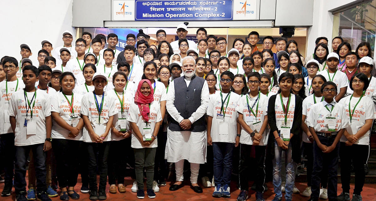 Prime Minister Narendra Modi interacts with the winners of the Space Quiz, at ISRO, in Bengaluru, Saturday, Sept. 7, 2019. (PIB/PTI Photo) 
