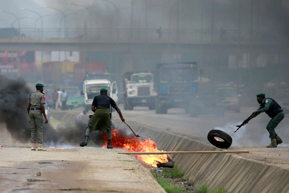Police officers remove flaming tires after protesters blocked traffic along Airport Road in Abuja, Nigeria September 4, 2019. REUTERS/Afolabi Sotunde