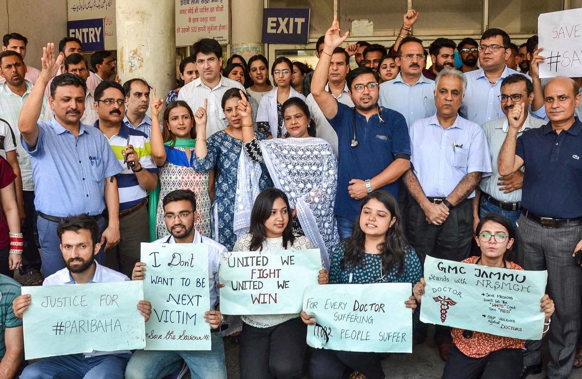 Government Medical College workers and doctors hold placards in protest against the assault on an intern doctor in West Bengal, in Jammu, Monday, June 17, 2019. PTI