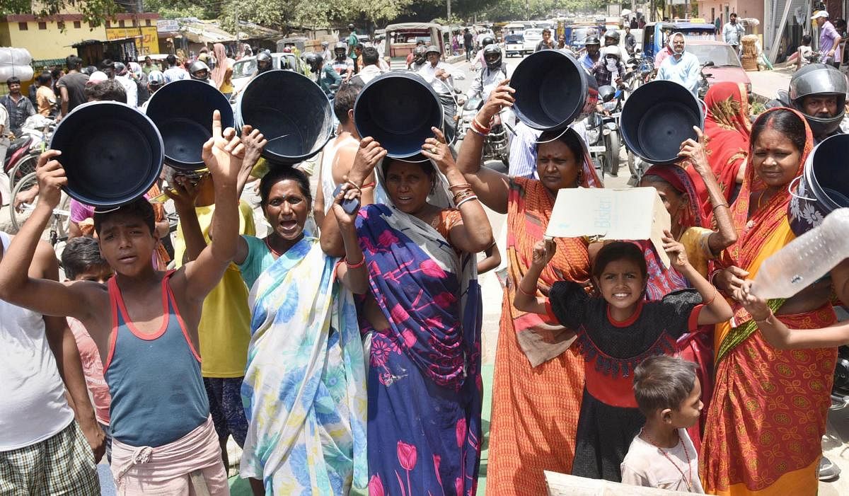 People block a road in protest demanding supply of potable water during a hot summer day in Patna, Saturday, June 15, 2019. PTI