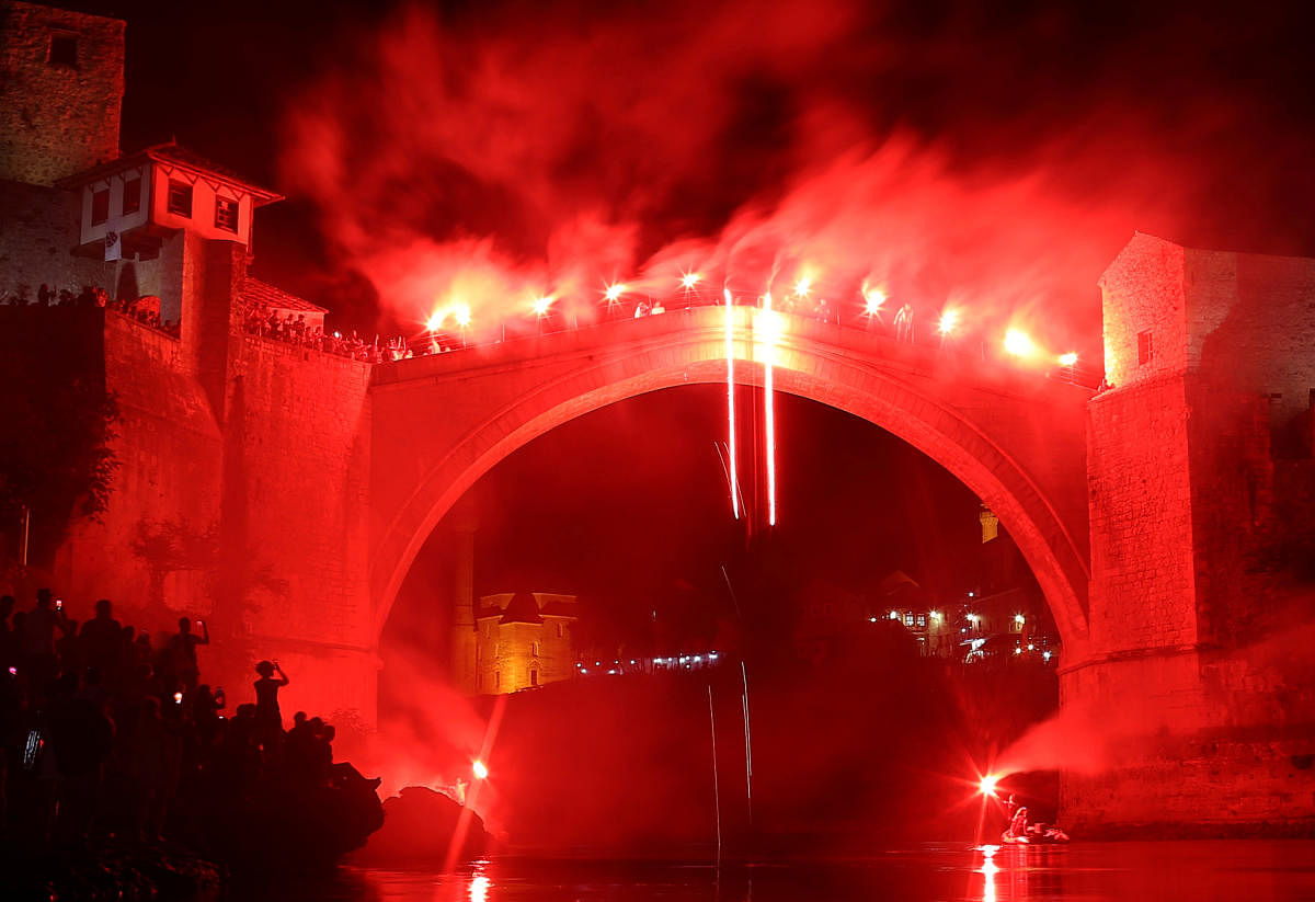 A man jumps from the Old Bridge during the 452nd traditional diving competition in Mostar, Bosnia and Herzegovina, July 29, 2018. REUTERS/Dado Ruvic