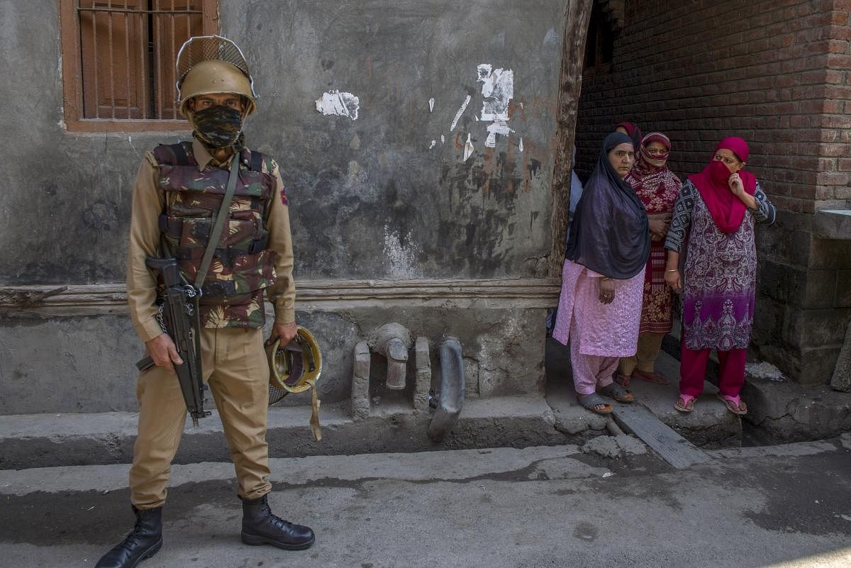 A policeman stands guard after militants shot dead two National Conference workers and injured an office bearer, three days ahead of the first phase of elections for urban local bodies at Karfali Mohalla in Down Town, Srinagar. PTI Photo