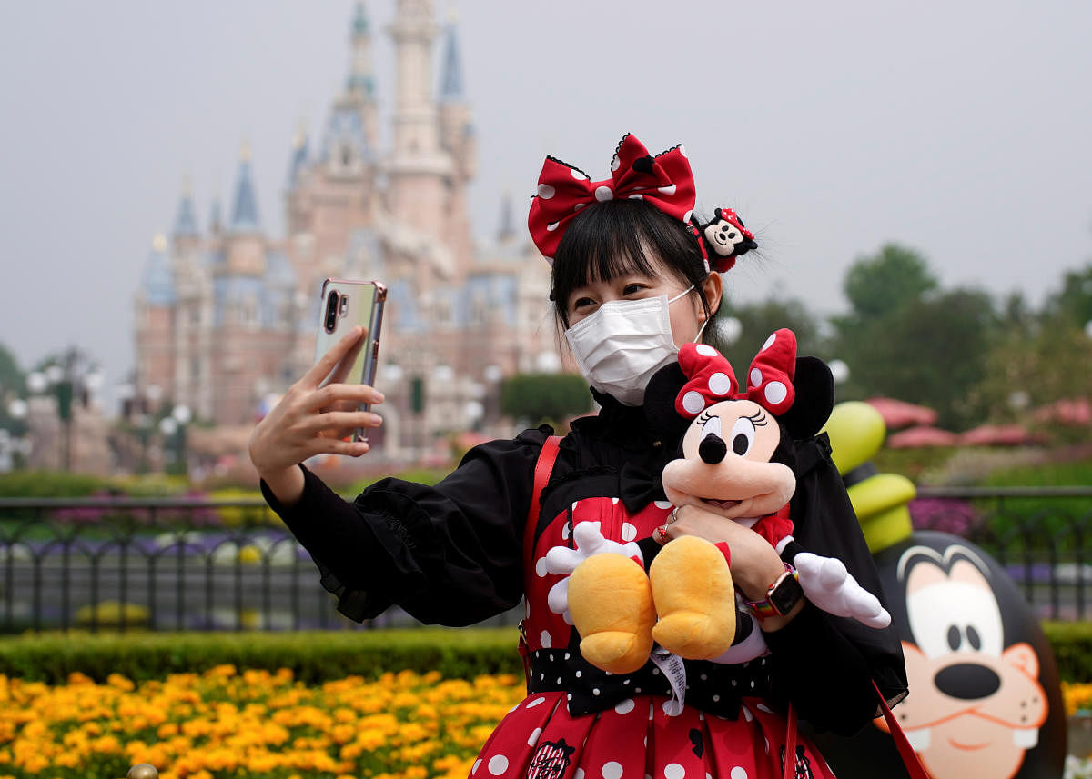 A visitor dressed as a Disney characters takes a selfie while wearing a protective face mask at Shanghai Disney Resort as the Shanghai Disneyland theme park reopens following a shutdown due to the coronavirus disease (COVID-19) outbreak, in Shanghai. Credit: Reuters Photo