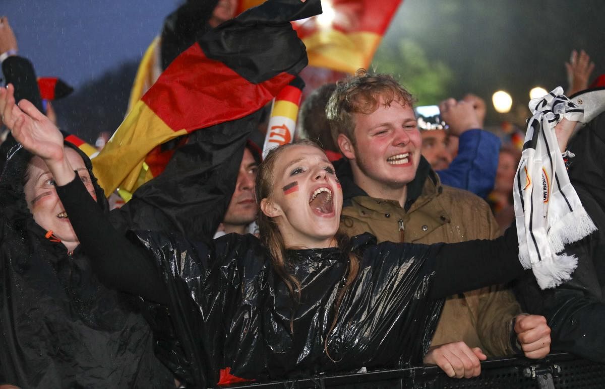 World Cup - Group F - Germany vs Sweden - Berlin, Germany - June 23, 2018 Germany soccer fans react as they watch the match at public viewing area at Brandenburg Gate. Reuters