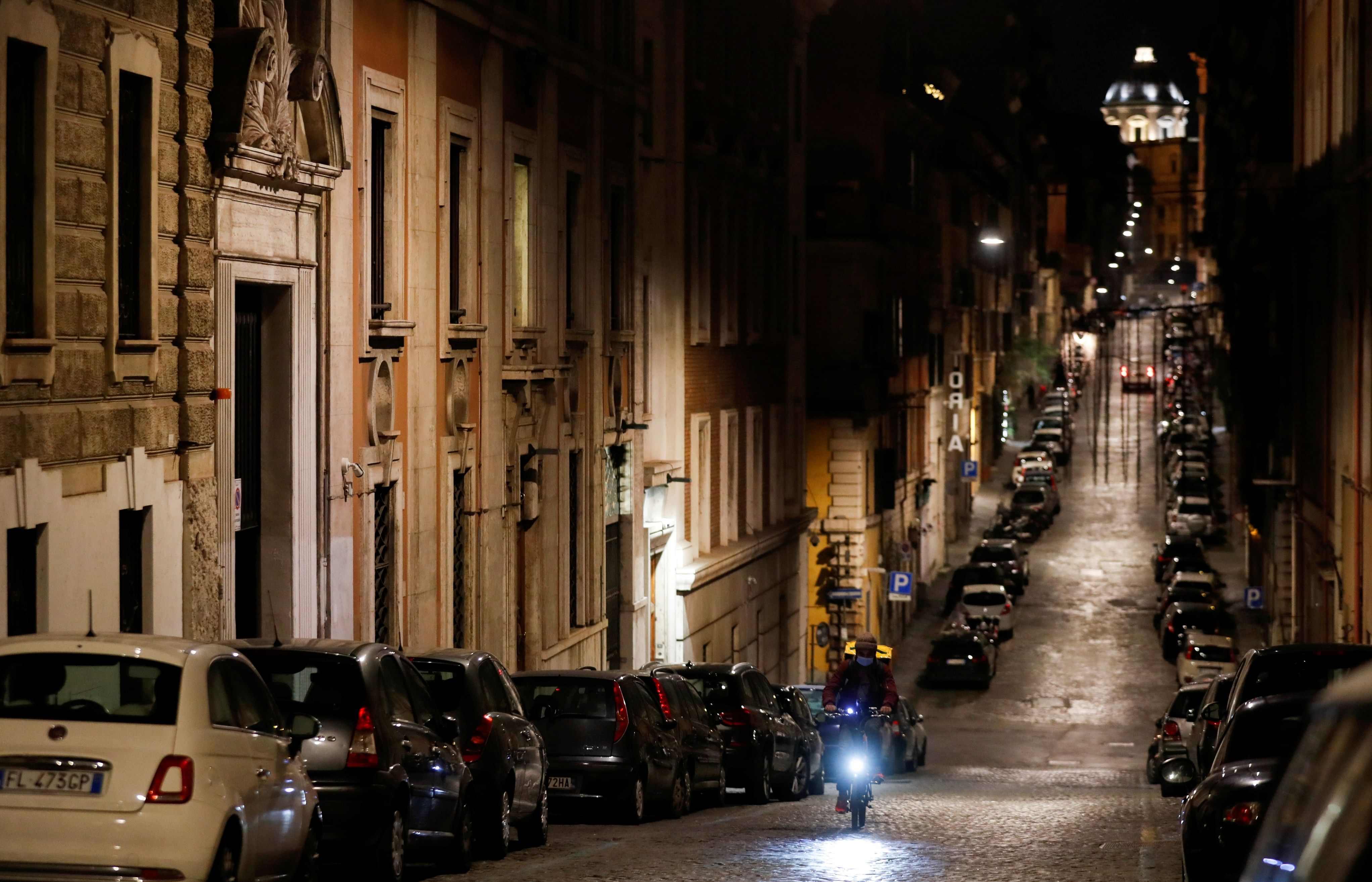 A rider is seen in an empty street in Rione Monti neighborhood, virtually deserted after a decree orders for the whole of Italy. (Credit: Reuters)