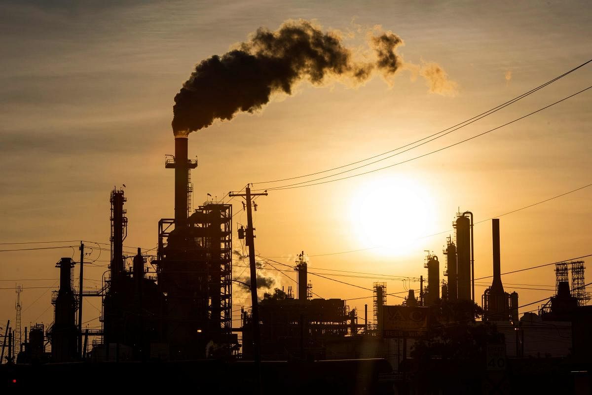  The sun sets behind smoke rising from the LyondellBasell-Houston Refining plant in Houston, Texas, on April 20, 2020. - US oil prices crashed to unprecedented lows on April 20 as futures in New York ended in negative territory for the first time amid a devastating supply glut that has forced traders to pay others to take the crude off their hands. Credit: AFP