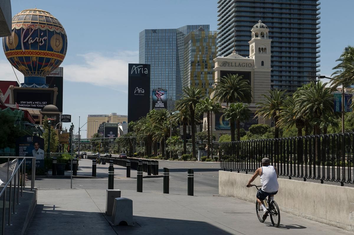 A biker cycles down a quiet Las Vegas Strip amid the novel coronavirus pandemic on May 8, 2020 in Las Vegas, Nevada. Credit: AFP Photo