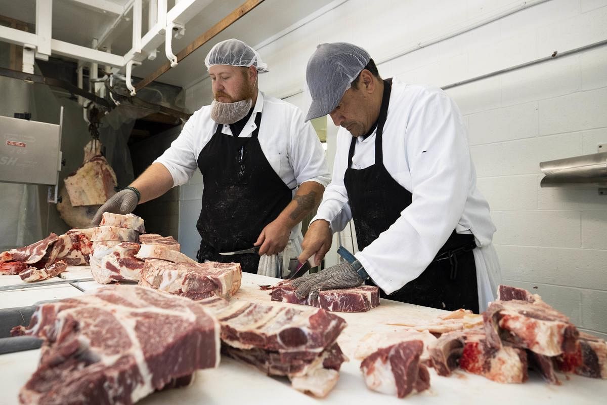 Butchers at Old Fashion Country Butcher process meat as they work to meet increased demand due to COVID-19 related shortages in California. (AFP Photo)