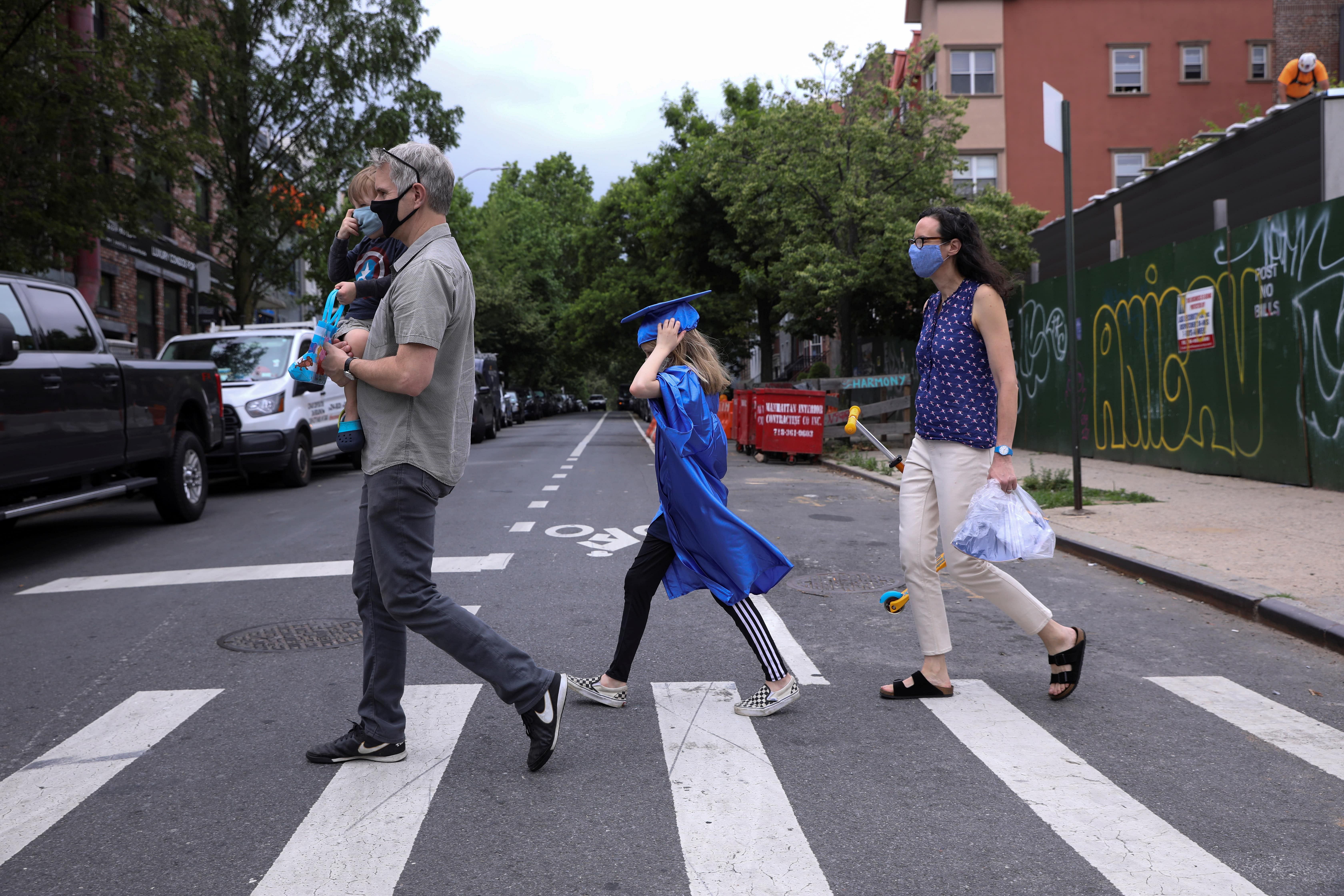 The Hassebroeks walk home after picking up supplies in preparation for Lydia Hassebroek's digital graduation during the outbreak of the coronavirus disease (COVID-19) in Brooklyn, New York. Credit: Reuters Photo
