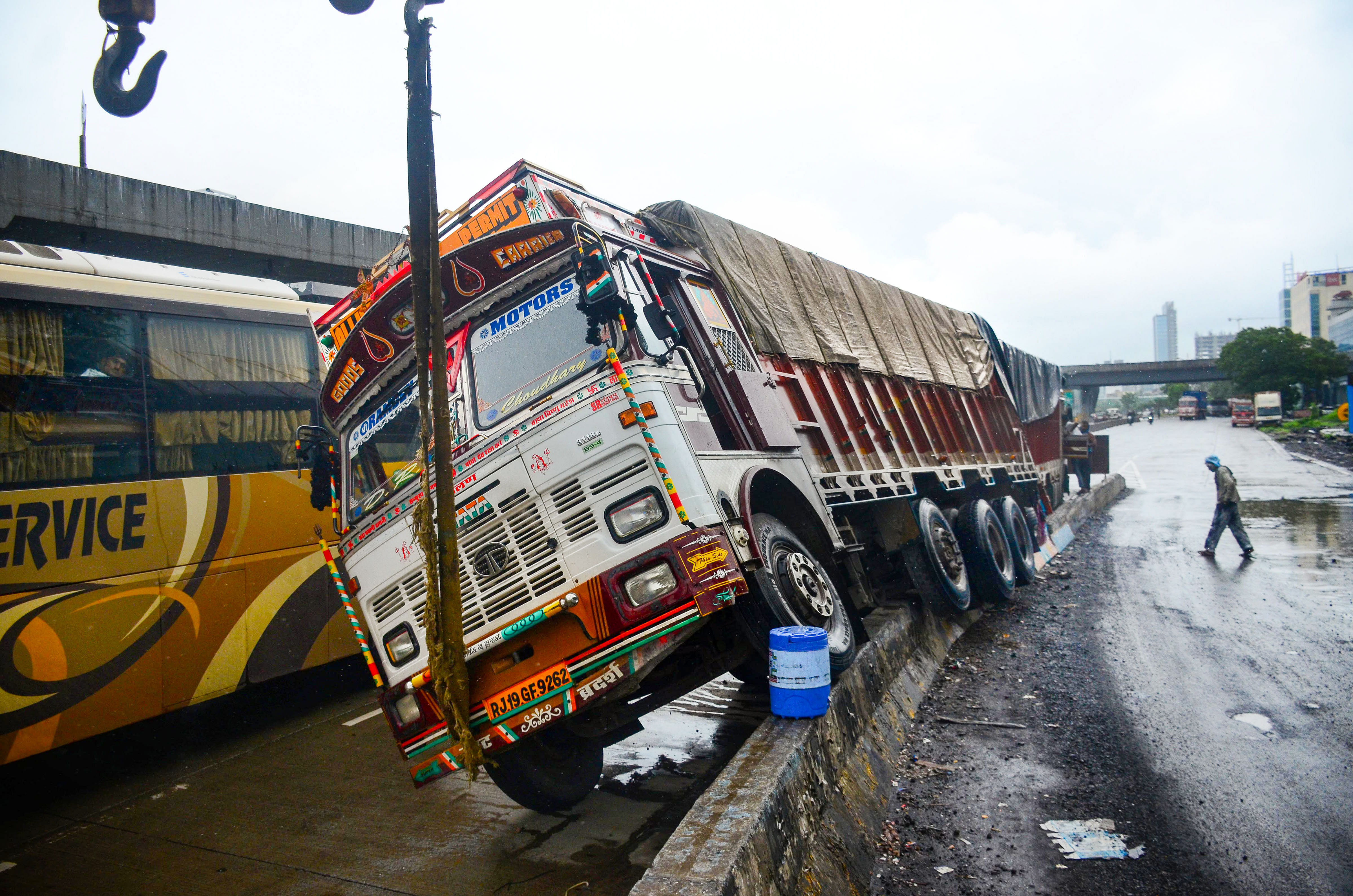 A loaded truck which overturned on the Sion Panvel Highway amid rains, near Turbhe in Navi Mumbai. Credits: PTI Photo