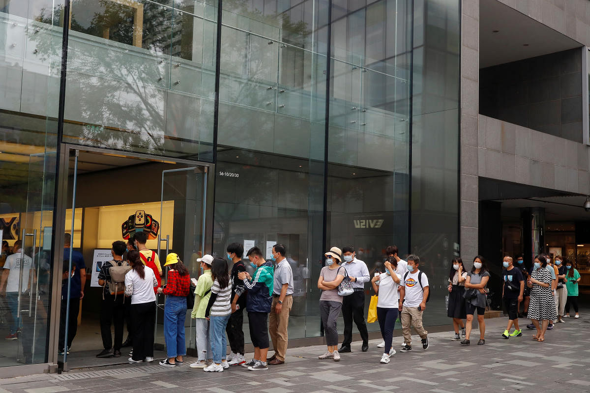 People line up before opening hours outside the Apple store in Sanlitun after an outbreak of the coronavirus disease in Beijing (Photo Reuters)