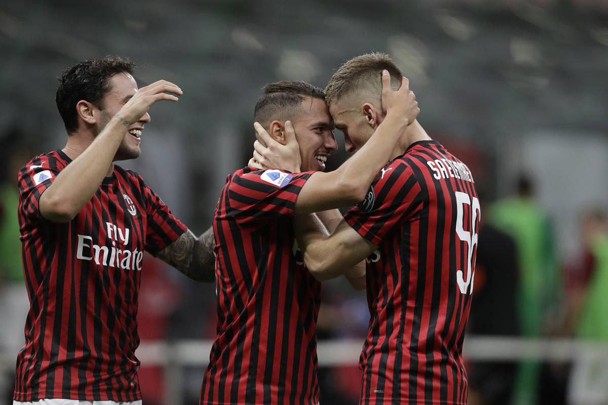AC Milan's Ismael Bennacer, centre, celebrates with teammate Alexis Saelemaekers, right, after scoring during a Serie A soccer match between AC Milan and Bologna, at the San Siro stadium in Milan, Italy, Saturday, July 18, 2020. Credit: AP/PTI