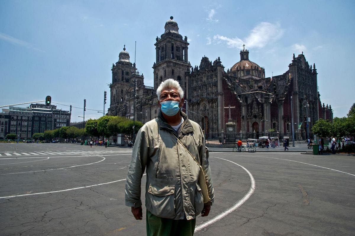 Mexican tour guide Jesus Yepez Lugo, who is unemployed due to the Covid-19 pandemic, poses in the historic center in Mexico City. Credit: AFP