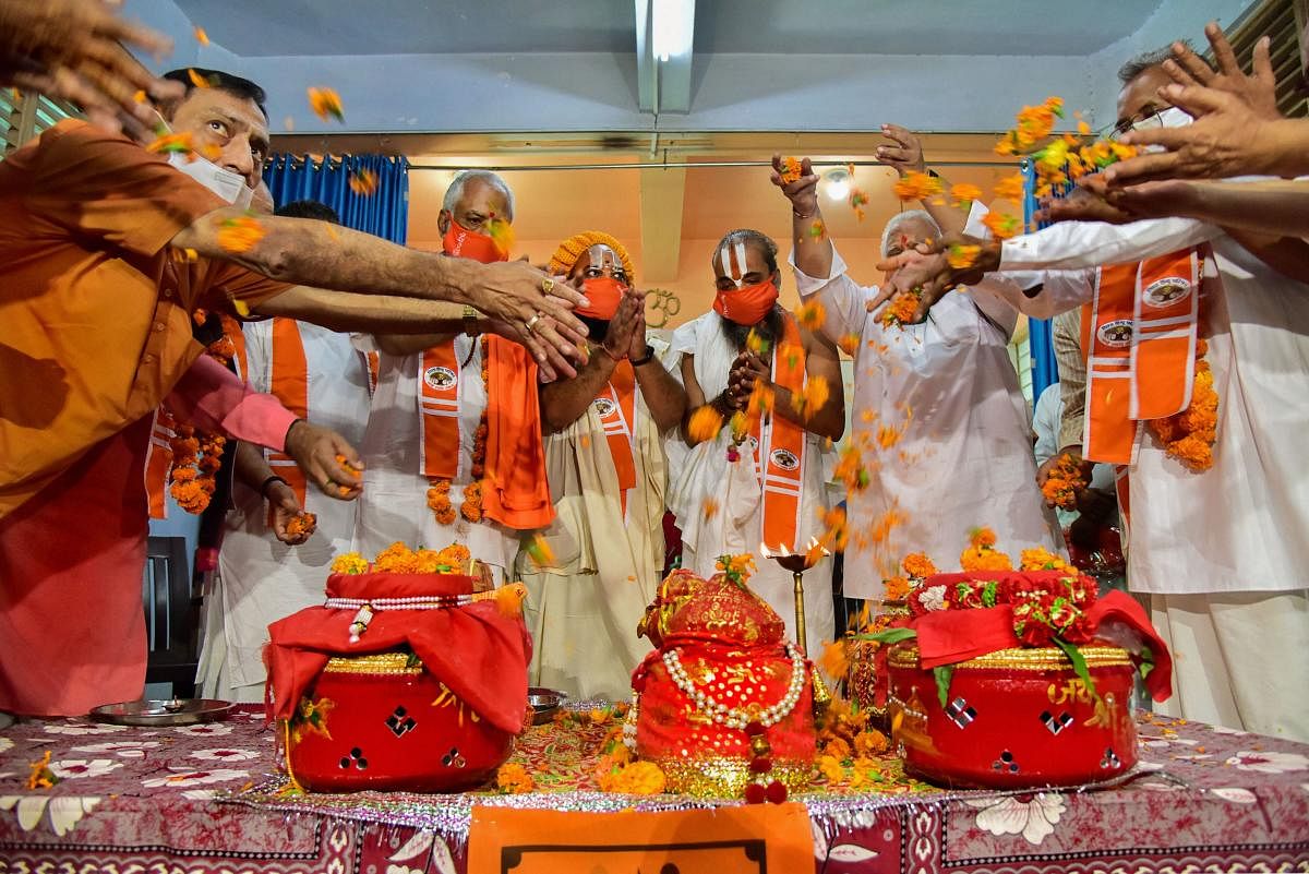 Members of Vishwa Hindu Parishad (VHP) and head priest of Jagannath temple Dilipda Ji Maharaj perform rituals before sending soil and water from different rivers of Gujarat for ground-breaking ceremony of Ayodhya's Ram Mandir, in Ahmedabad, Monday, July 27, 2020.  Credit: PTI Photo